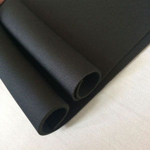 Black neoprene rubber sheet fitted beneath machinery on a factory floor for vibration and impact protection