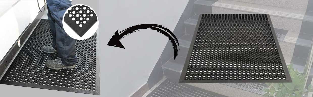 Worker standing safely on oil-resistant rubber mat in a UK garage workshop