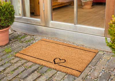 Heavy-duty outdoor coir doormat on a UK doorstep, resisting rain and dirt with no curling or shedding